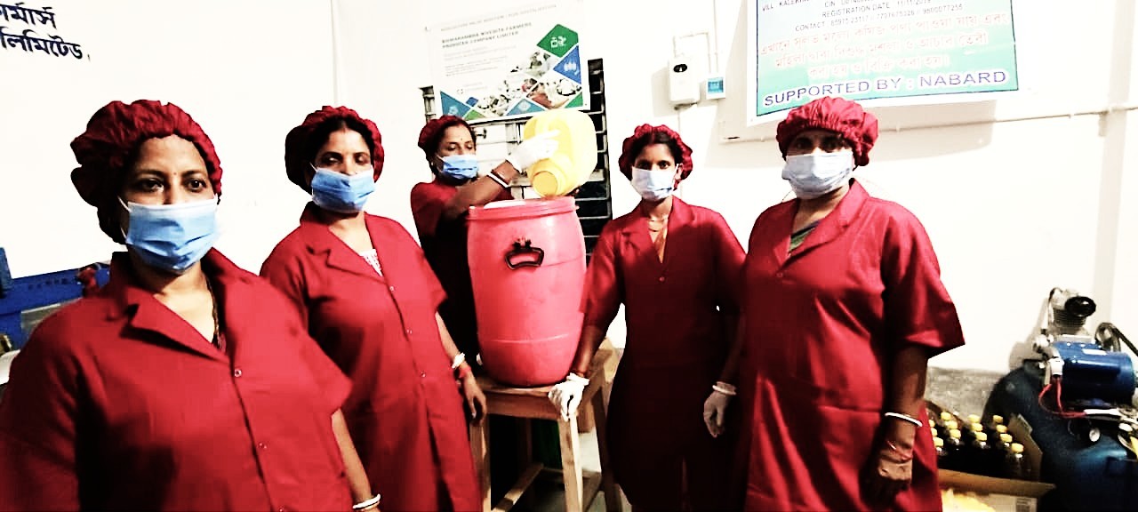 Women farmers processing mustard seeds